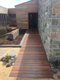 Natural oil finish on timber to blend with the natural stone