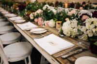 Long wooden tables and chairs for wedding reception