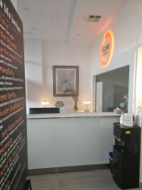 The reception at iflow Psychology in Gladesville offers a calm and professional welcome, featuring warm lighting, simple décor, and a comfortable waiting area.