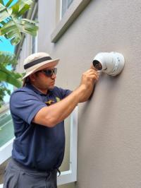 Sparkytech's technician is installing cameras in a residential property